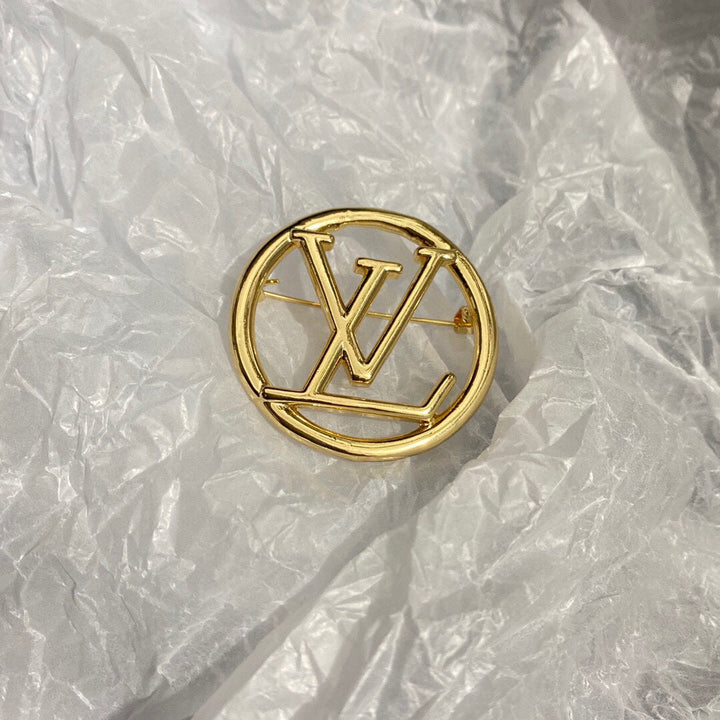 Gold letter brooch