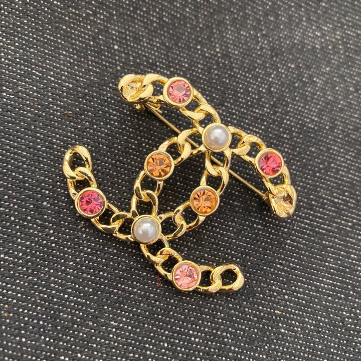 Gold-colored rhinestone brooch